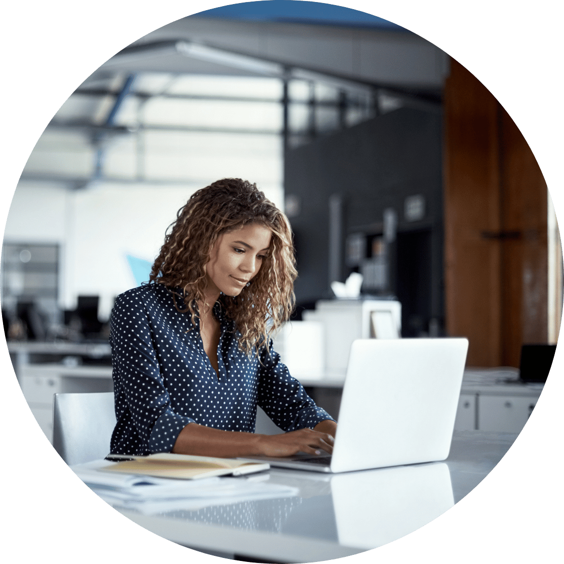 A woman typing at her desk