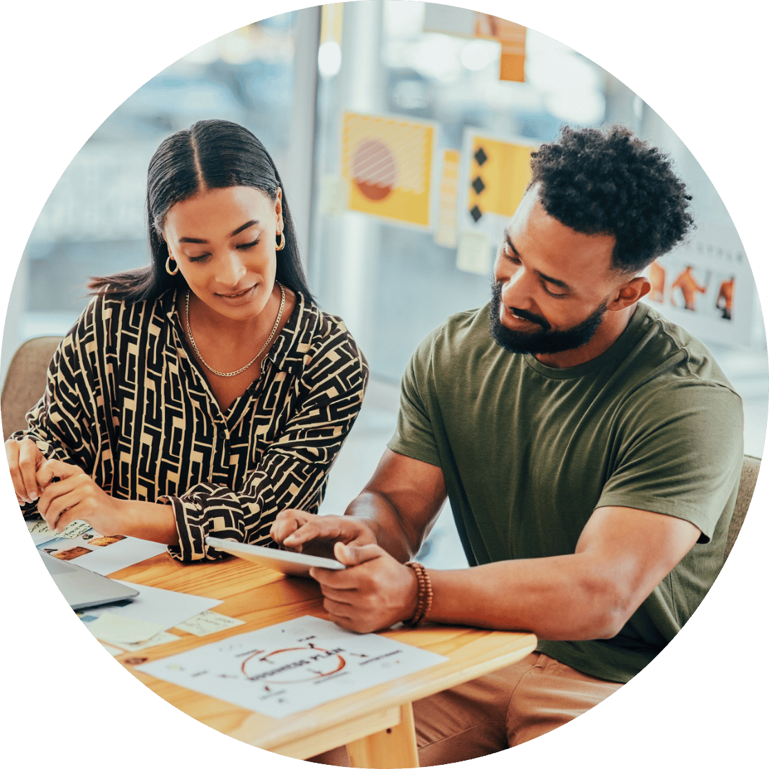 Two coworkers collaborating at a desk