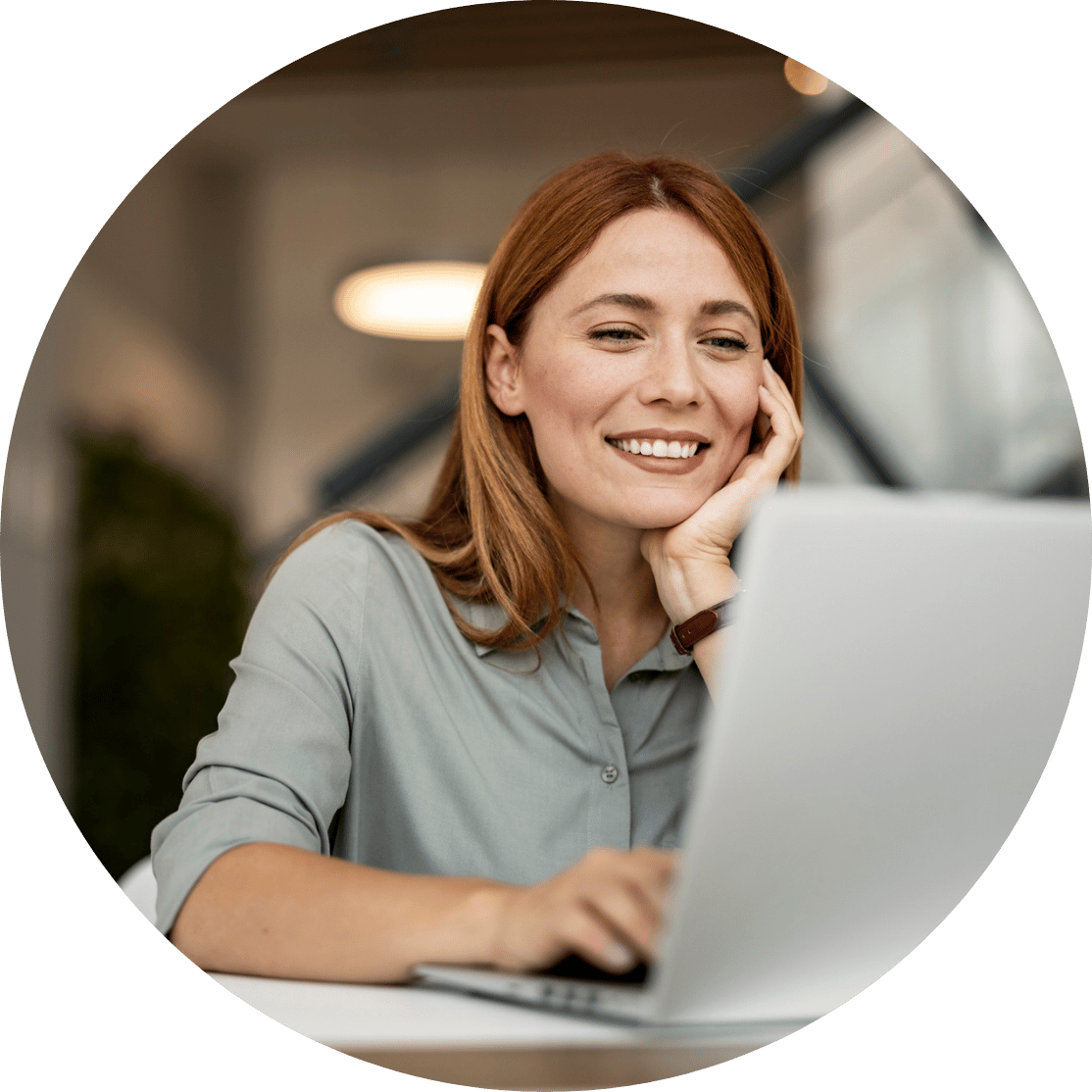 A woman looking at a laptop and smiling