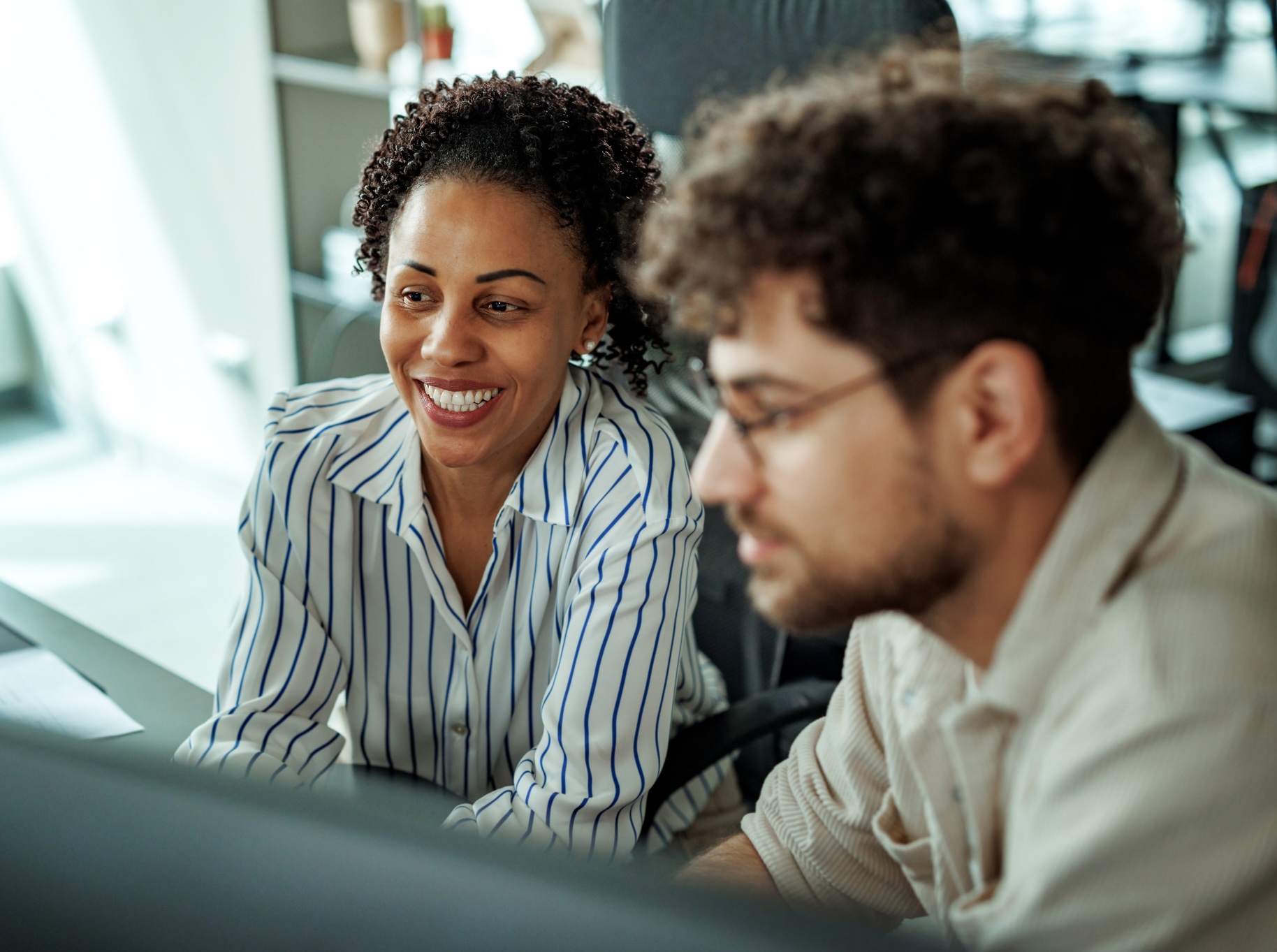 A woman smiling with a coworker
