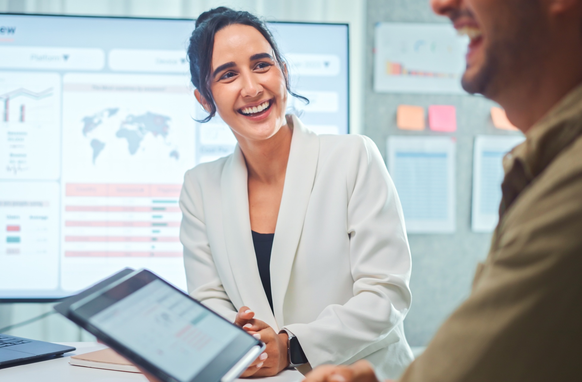 A woman smiling in a work meeting