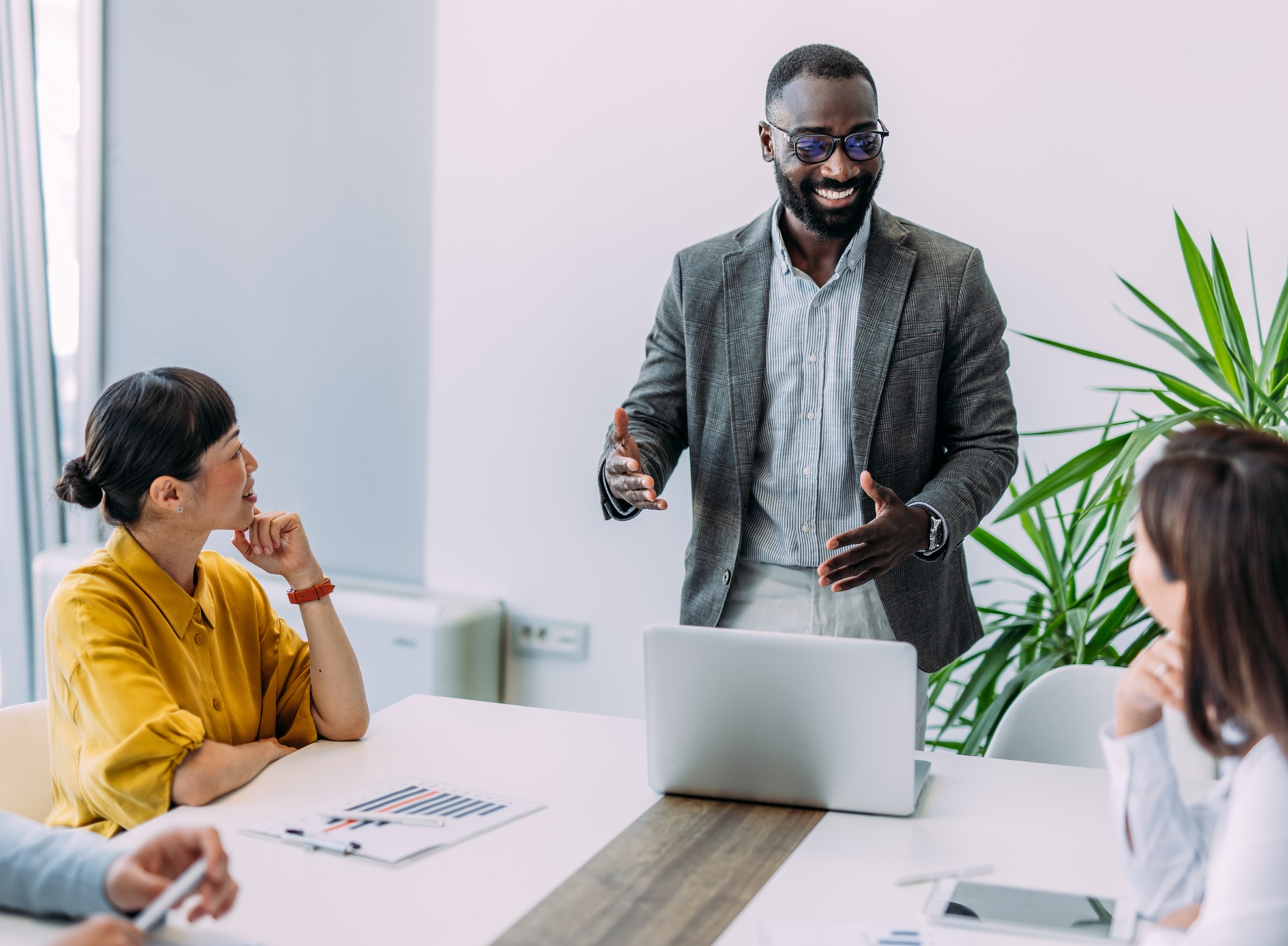 A man standing and talking in a meeting