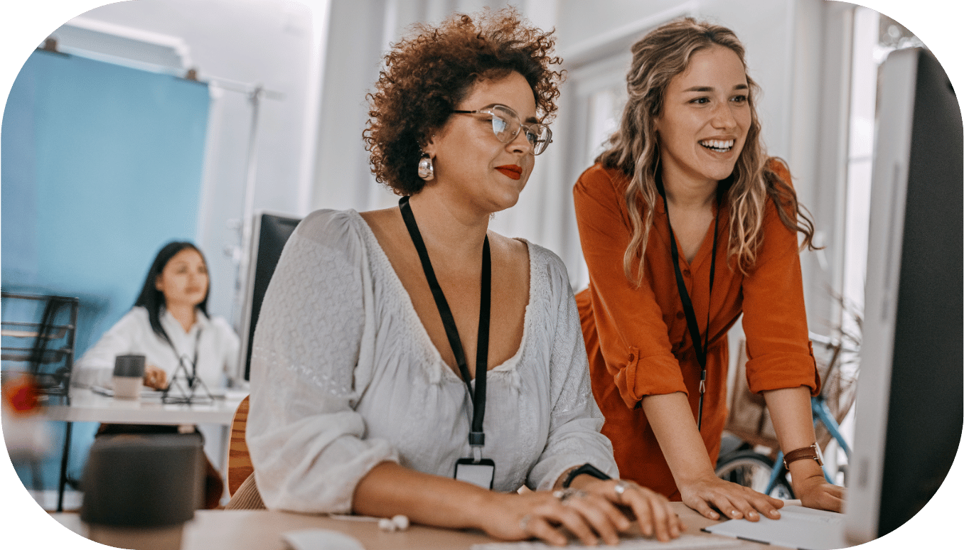 Two women collaborating on a computer