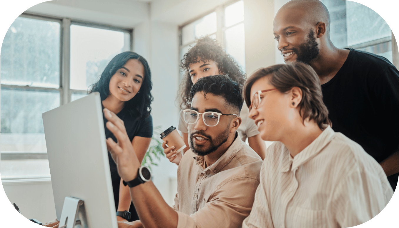 Five coworkers around a desktop