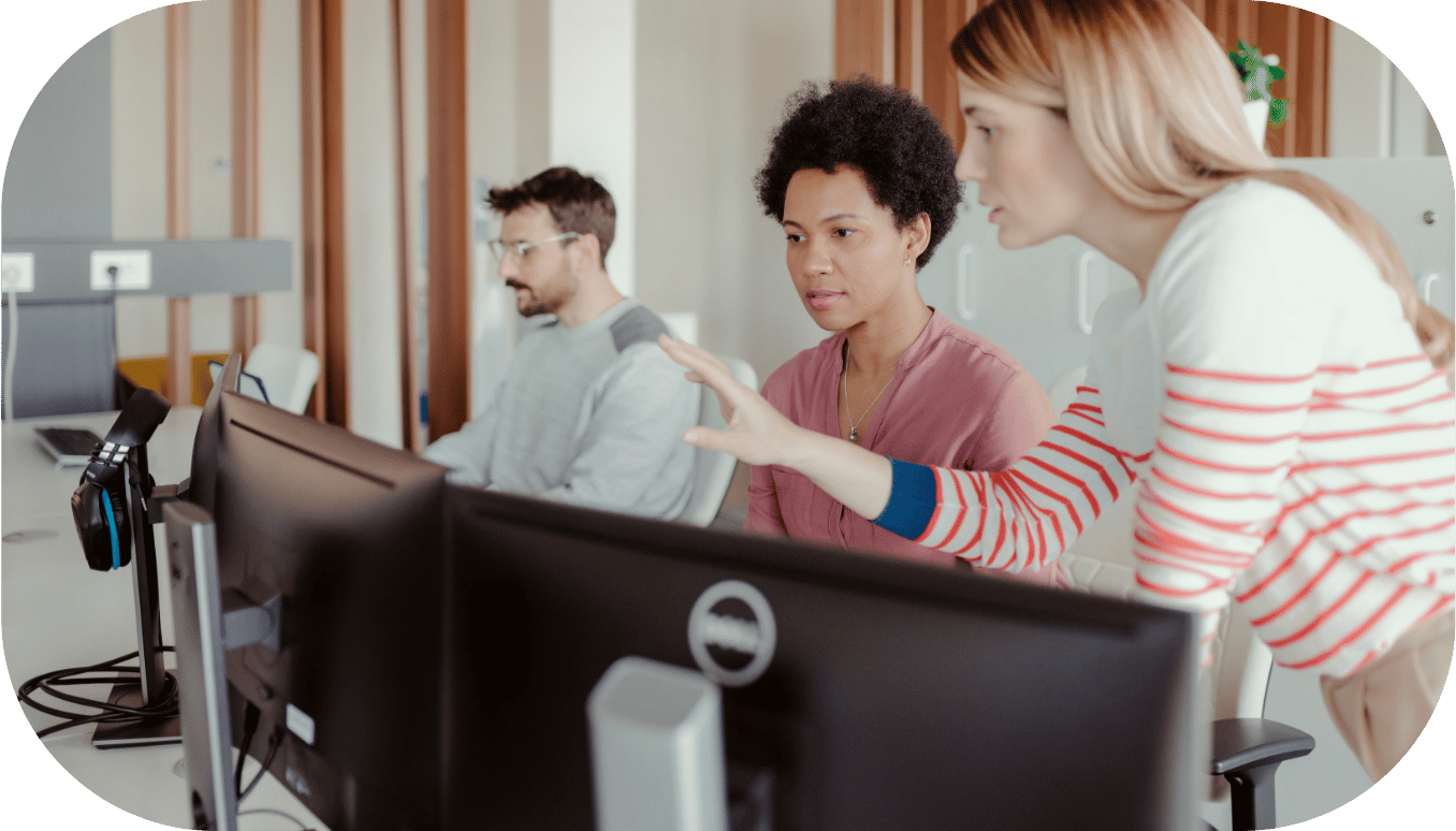 Three coworkers around a computer