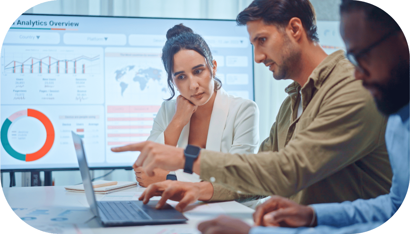 Three coworkers collaborating around a laptop