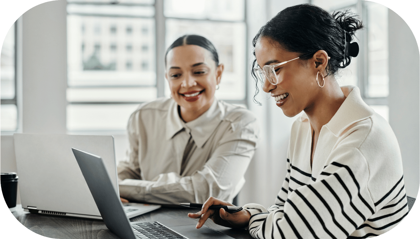 Two women around a laptop