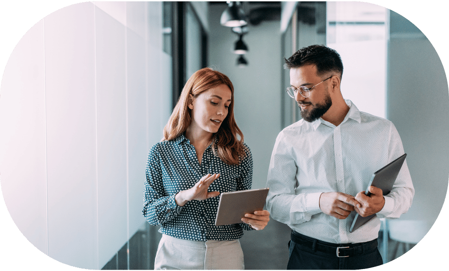 Two coworkers viewing a tablet