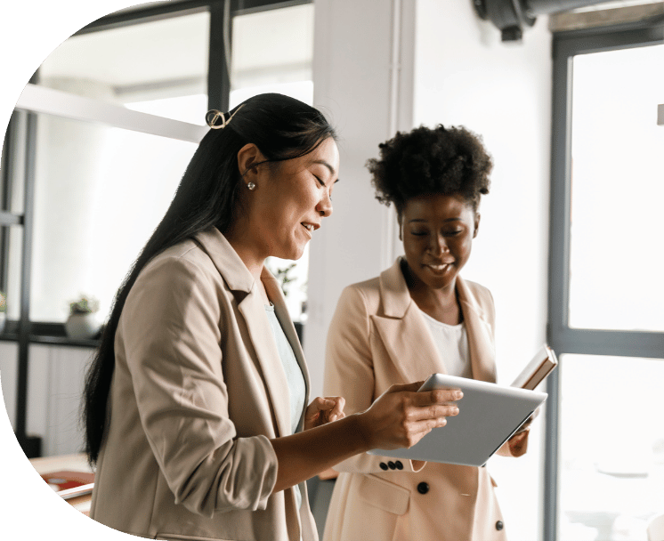 Two coworkers viewing a tablet
