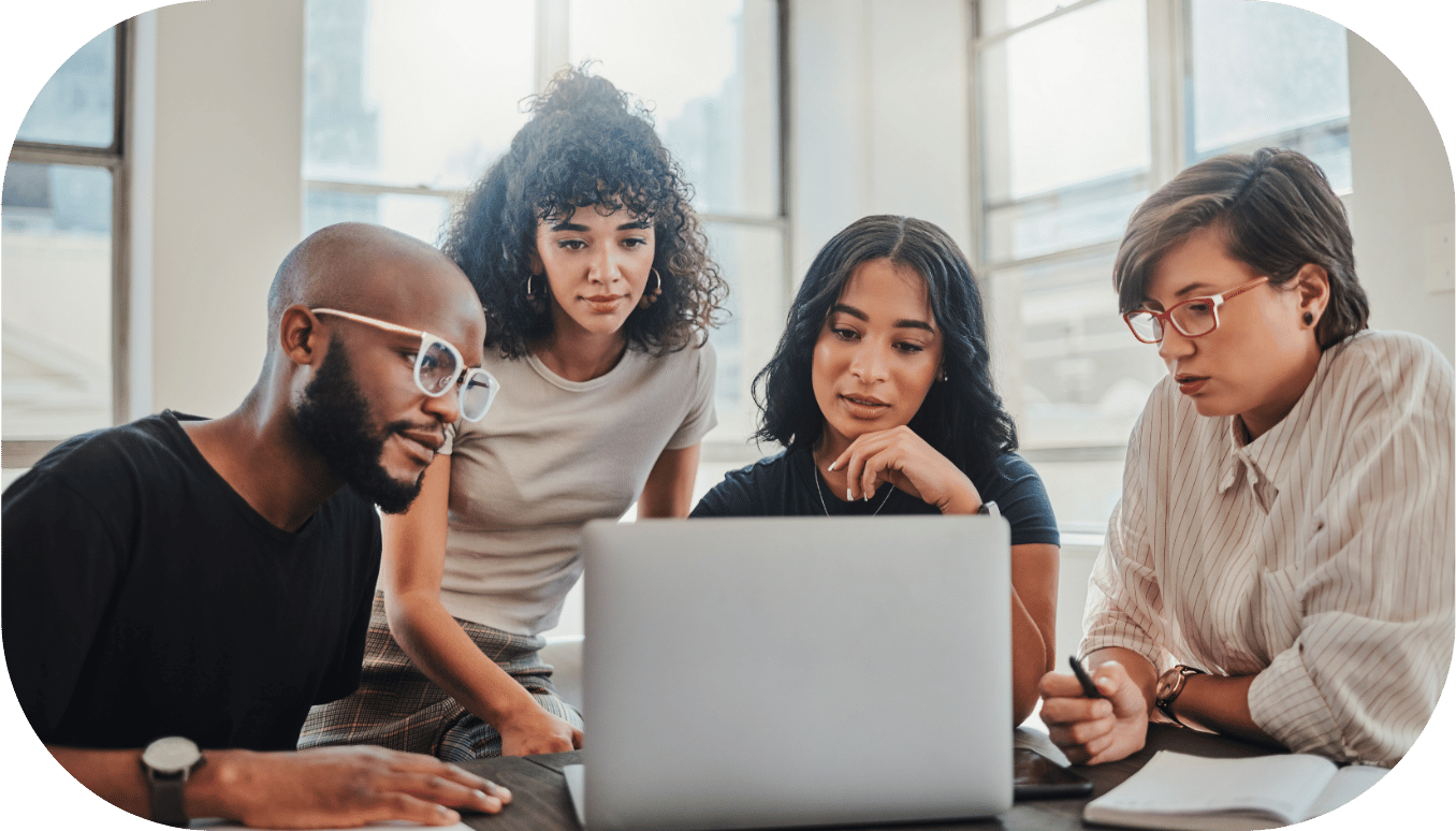 Four coworkers around a laptop