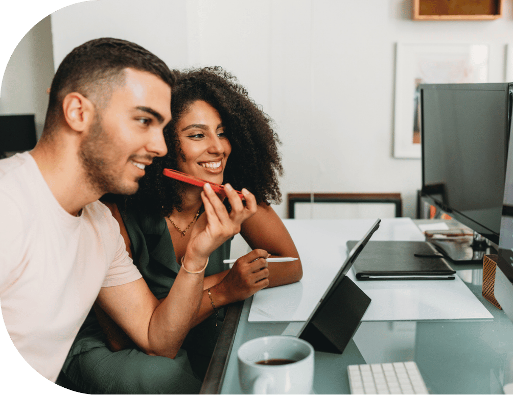 Two people on the phone at a desk