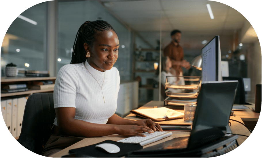 A woman typing at her desk