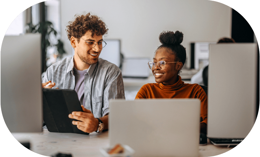 Two coworkers talking at a desk