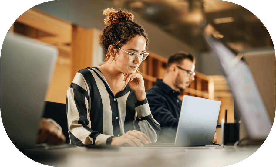 A woman concentrating at her laptop