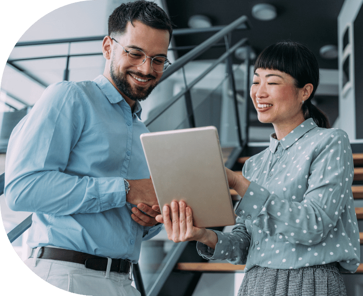 Two coworkers reviewing a tablet