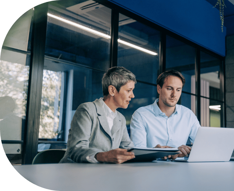 Two coworkers collaborating in an office