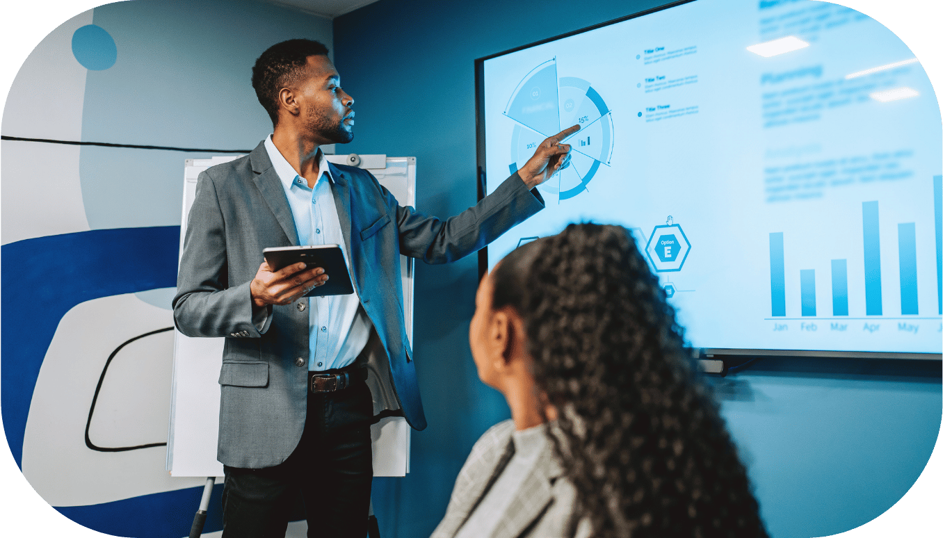 A man pointing to an analytics presentation