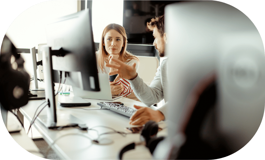 Two coworkers looking at a computer