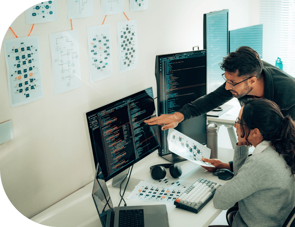 A man helping a coworker with a coding project