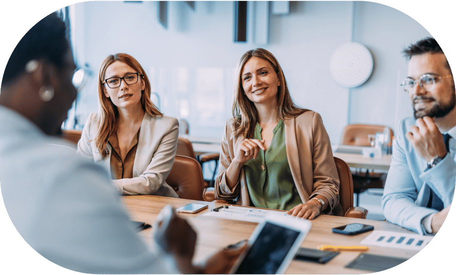 People smiling in an office meeting closeup