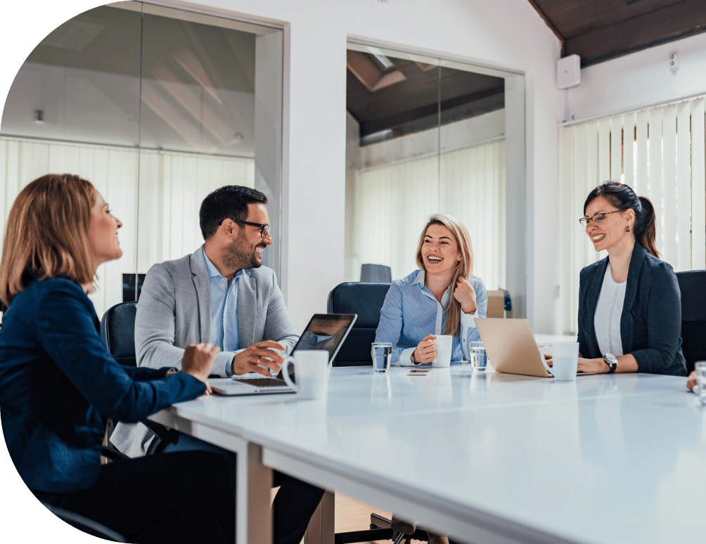 Distant shot of people smiling in an office meeting