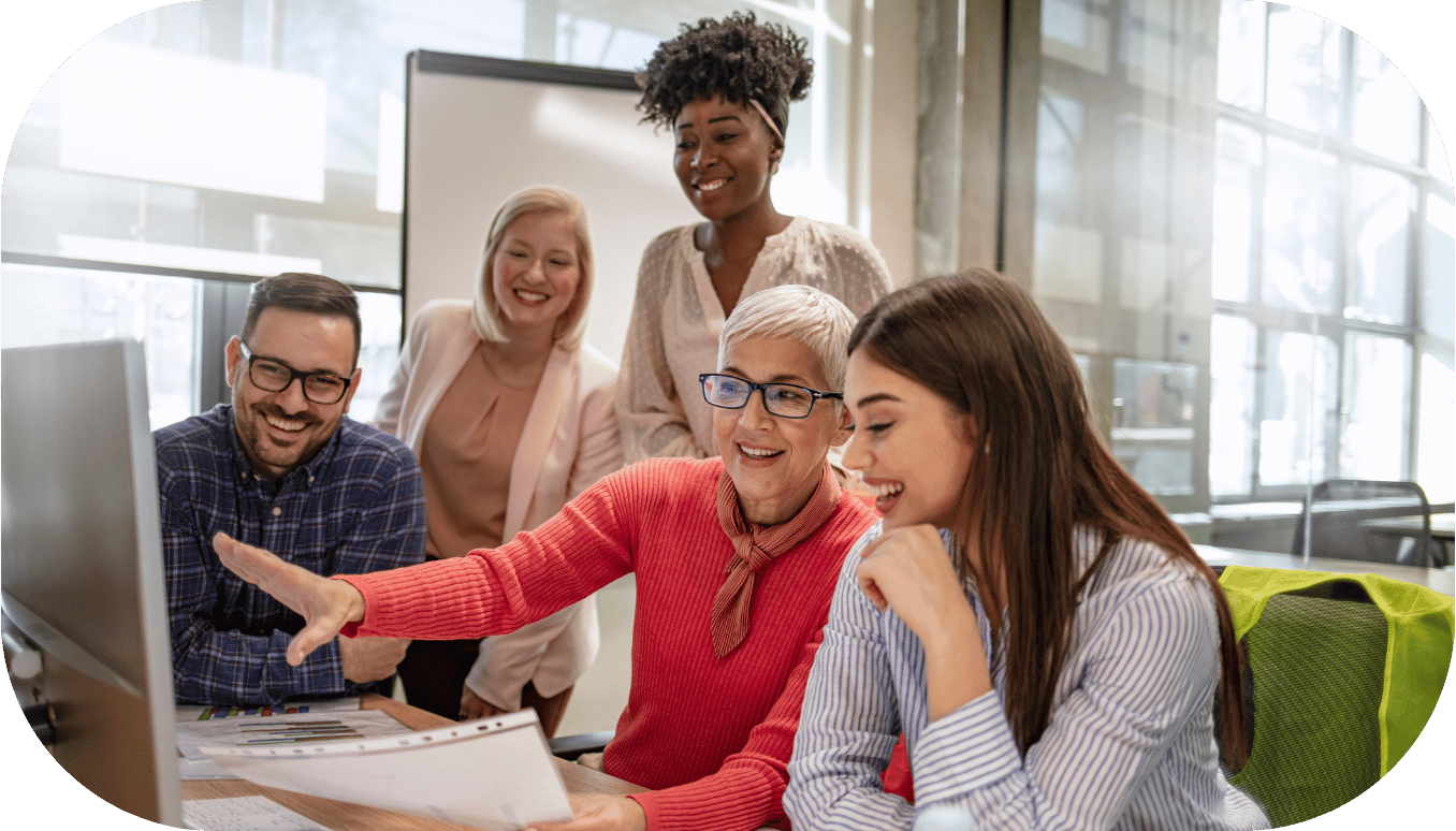 A group of coworkers looking at a computer