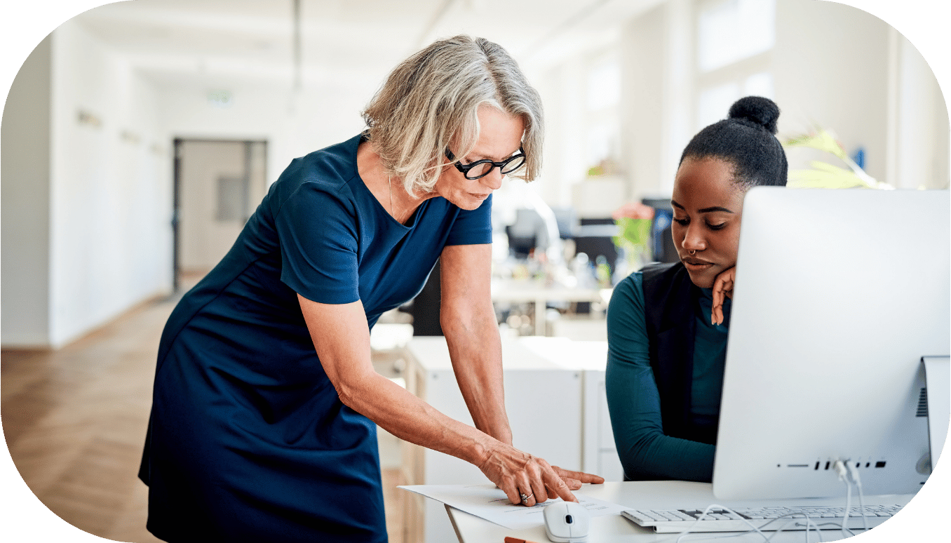 Two women reviewing a document at a desk