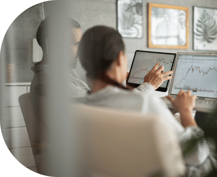 Two coworkers reviewing graphs